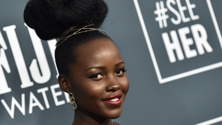 Lupita Nyong'o posing at a red carpet event