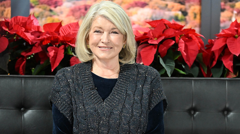 Martha Stewart in front of poinsettias
