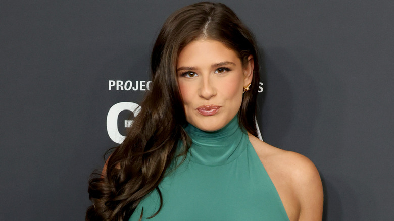 Remi Bader on the red carpet in a green dress