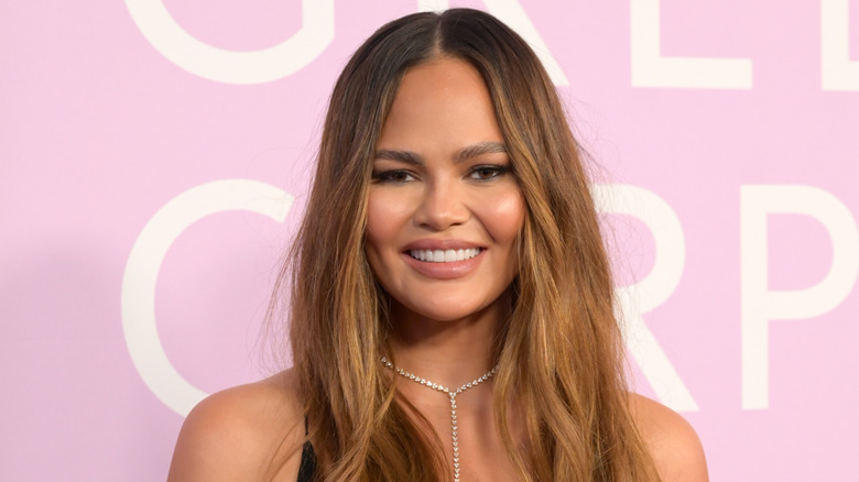 Chrissy Teigen on the red carpet smiling