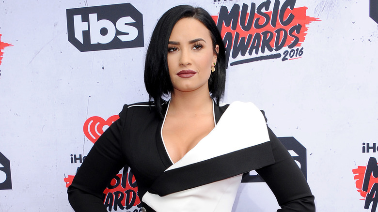 Demi Lovato on the red carpet in a black and white dress