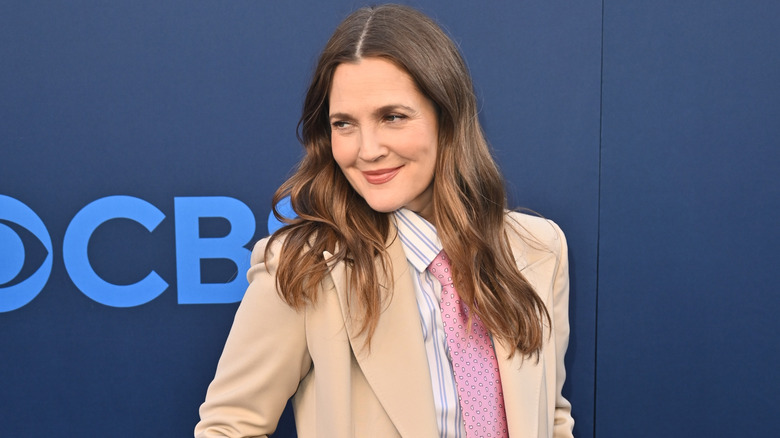 Drew Barrymore on the red carpet in a tan suit
