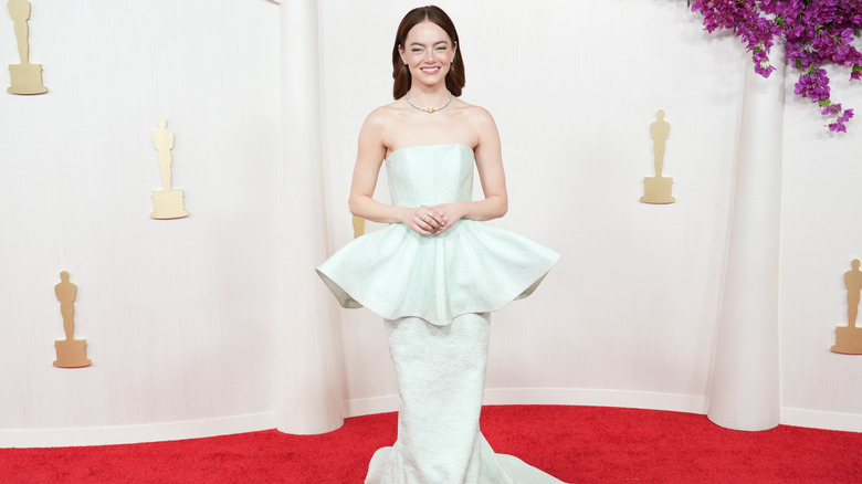 Emma Stone poses on the Oscars red carpet