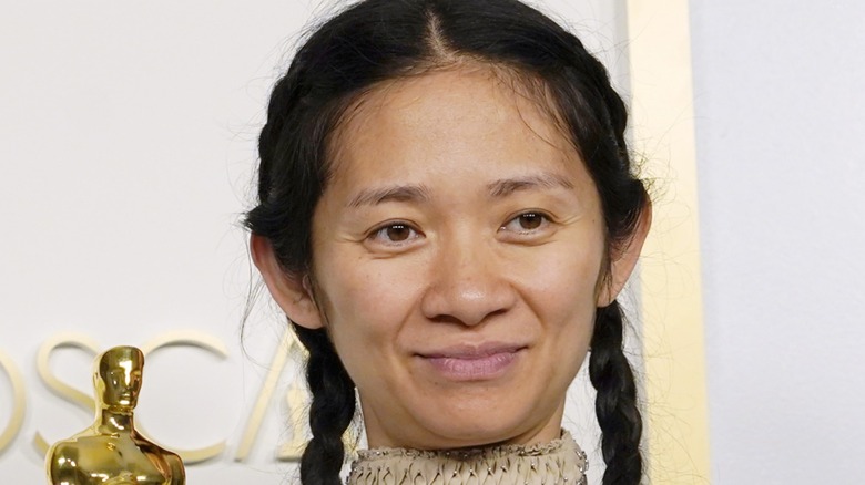 Chloé Zhao on the 2021 Oscars red carpet with her Oscar but not wearing makeup.