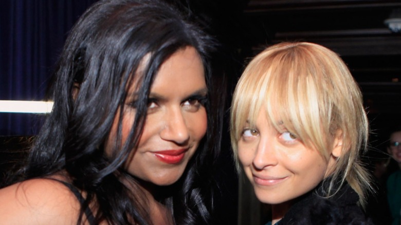 Mindy Kaling posing alongside Nicole Richie, who isn't wearing makeup, at a 2011 Glamour party.