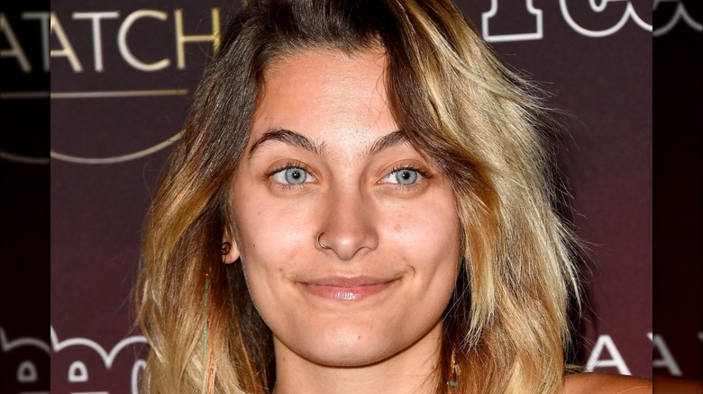 Paris Jackson smiling while not wearing makeup at a People event in 2017.