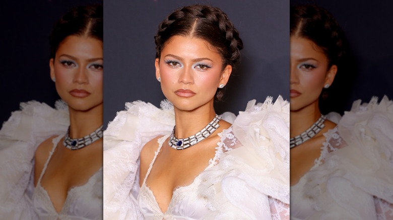 Close-up of Zendaya looking into the camera while wearing a braided hairstyle and light-colored eyeshadow