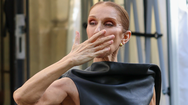 Celine Dion blowing a kiss outside her Paris apartment in 2026