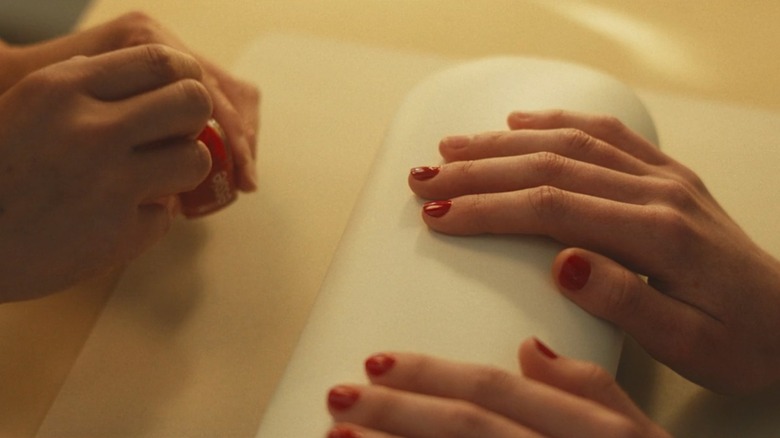 A close-up of CKB's nails in FX's "Love Story" on Hulu showing red polish