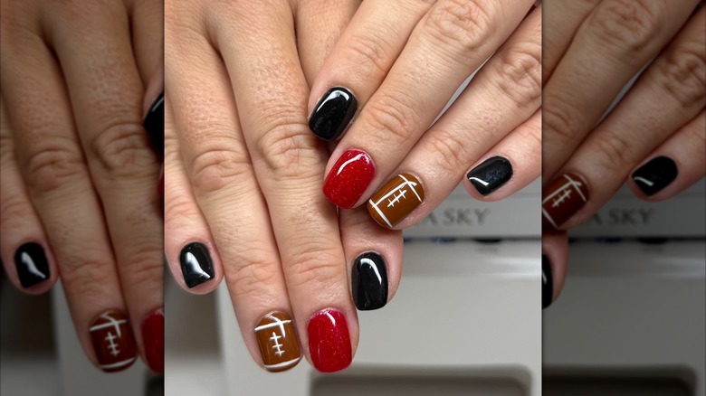 A close up of a black, red and brown NFL manicure on Instagram