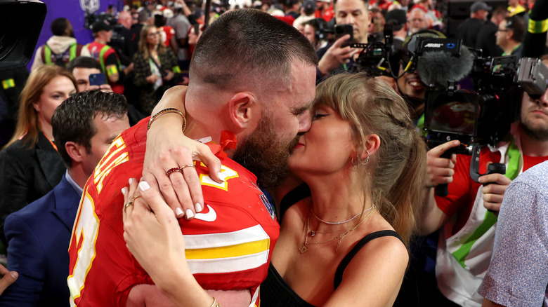 A close up of Taylor Swift's nails while she kissed Travis Kelce
