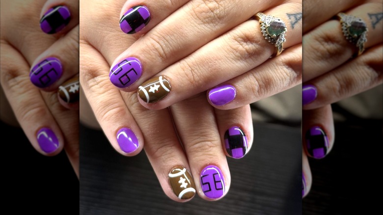 A close-up of a purple manicure with football details on Instagram