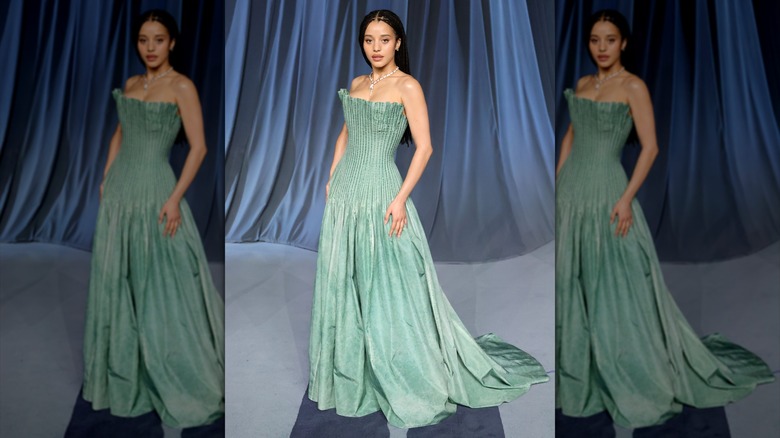 Chase Infiniti wearing a floor-length gown with a pleated, structure bodice