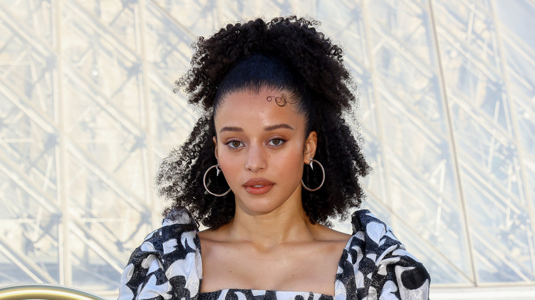 Chase Infiniti wearing a black and white dress