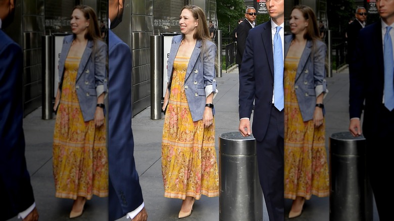 Chelsea Clinton smiling in a dress and blazer