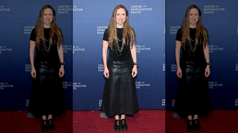 Chelsea Clinton in a black top and skirt
