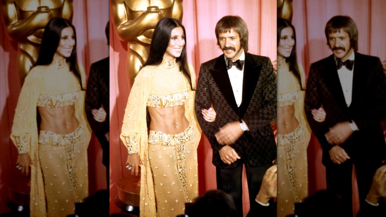Cher wearing a two-piece yellow ensemble with her hand on Sonny Bono's arm