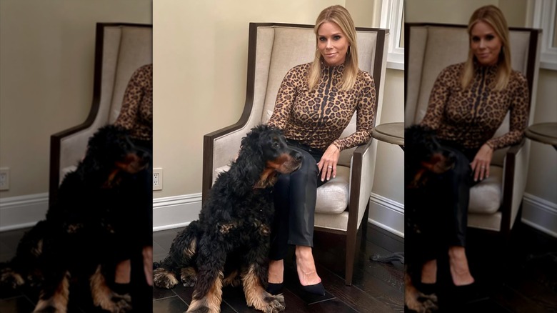 Cheryl Hines sitting in a chair next to her dog