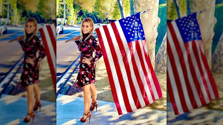 Cheryl Hines holding a flag outside after the 2020 election