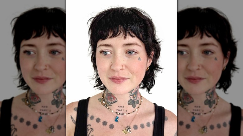 Woman with tattoos and dark shullet cut