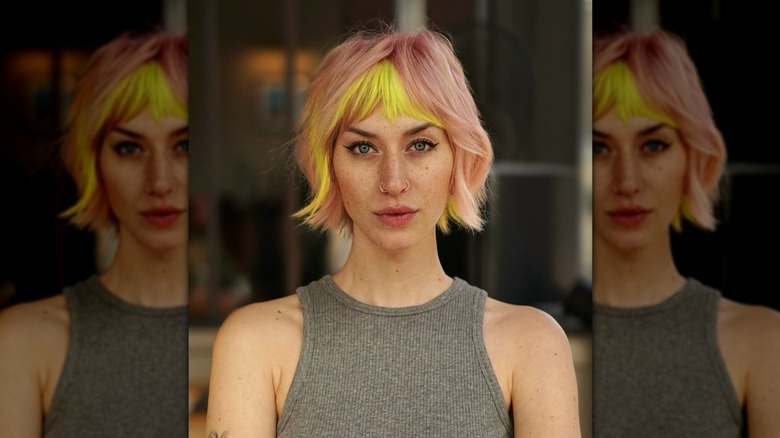 Woman with pale pink and yellow bixie haircut