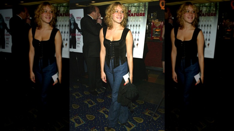Chloë Sevigny smiling to the side while wearing a corset top at a 2002 movie premiere