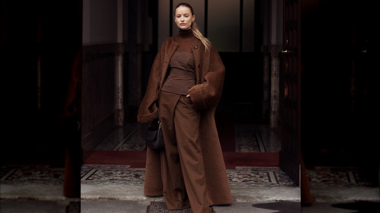 A woman in a brown turtleneck 