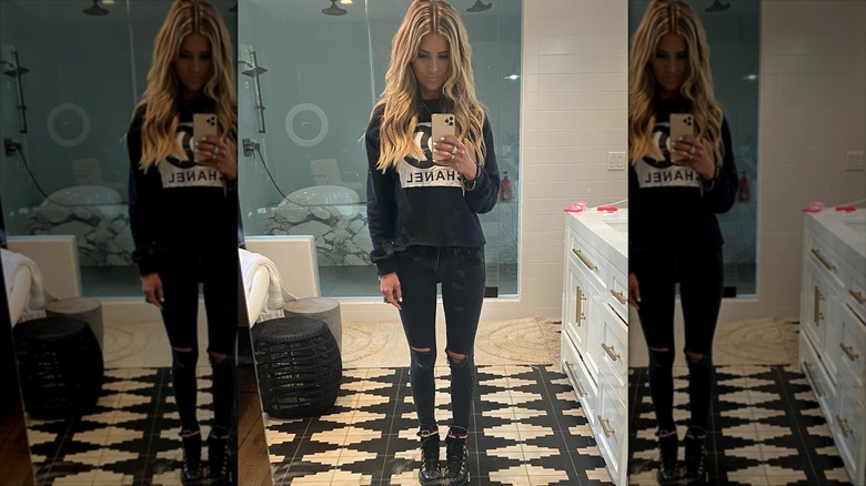 Christina Haack taking a mirror selfie in a black outfit
