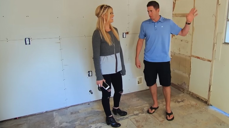 Christina Haack and Tarek El Moussa in a living room under construction