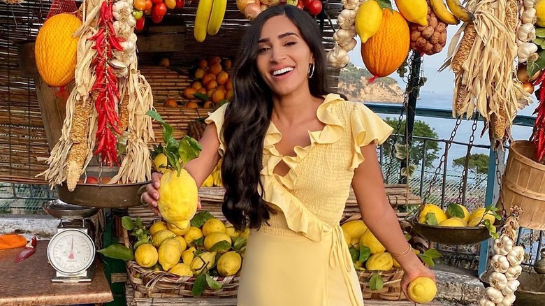 Woman holding lemons