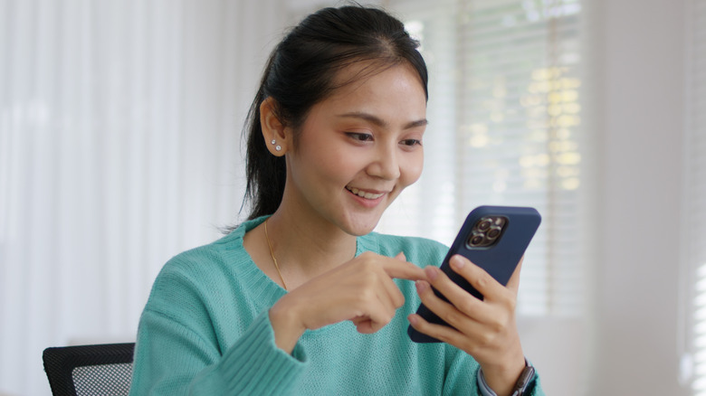 Woman scrolling on her phone