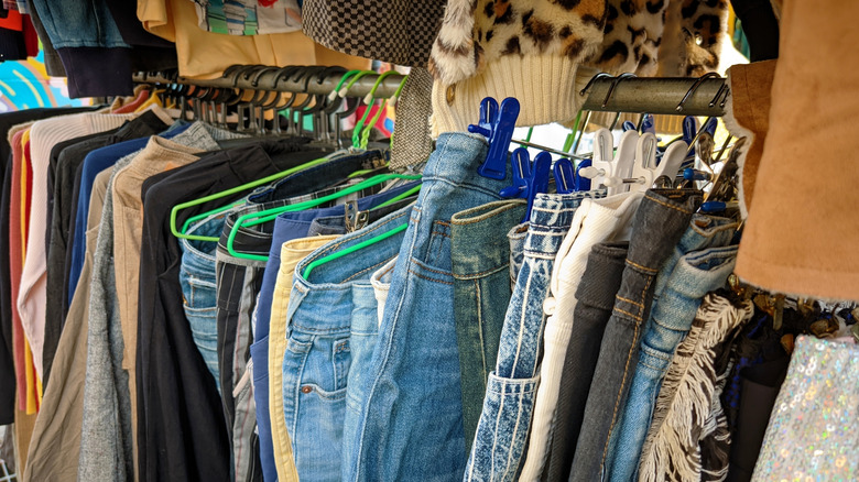 Rack of denim pants at thrift store