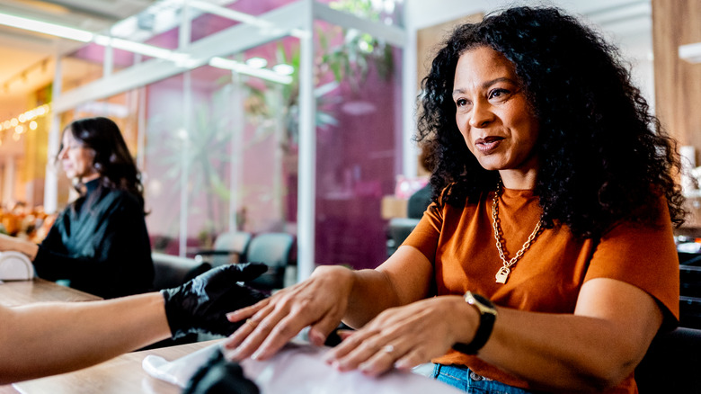 Woman getting her nails done at a salon