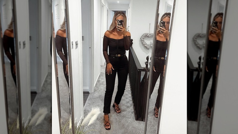 Wearing all-black outfit