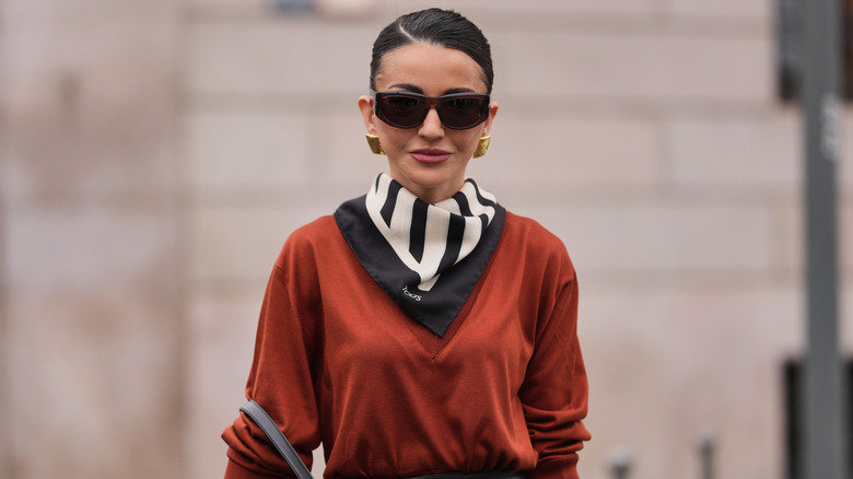 Woman wearing rust red sweater