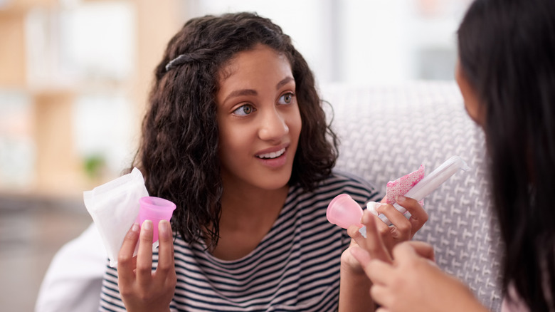woman holding menstrual cups