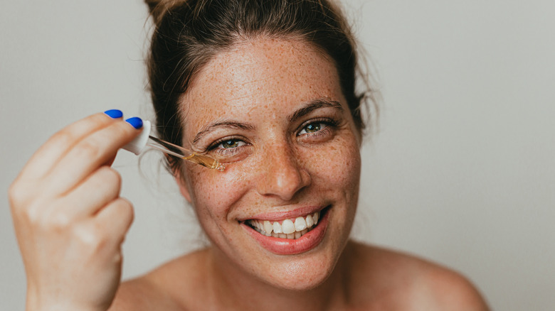 Woman applying serum 