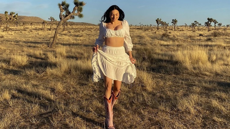 Woman in a dress, skirt and cowboy boots