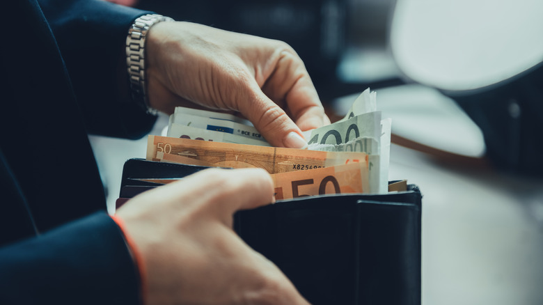 woman holding cash