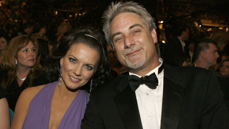Martina and John McBride smiling and leaning against each other in 2007