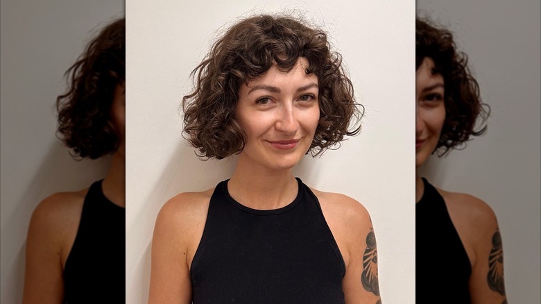 A woman with a chin-length French bob with bangs
