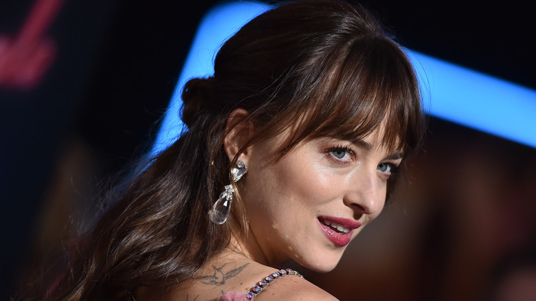 Dakota Johnson's face on the red carpet with a big crystal earring