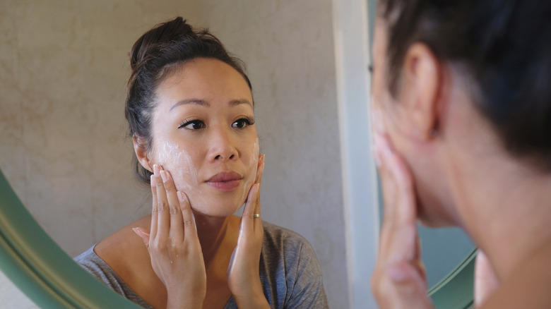 woman cleansing face