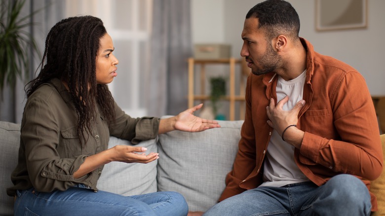 couple arguing on couch