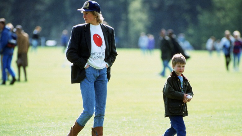 Princess Diana and Prince William walking outside 