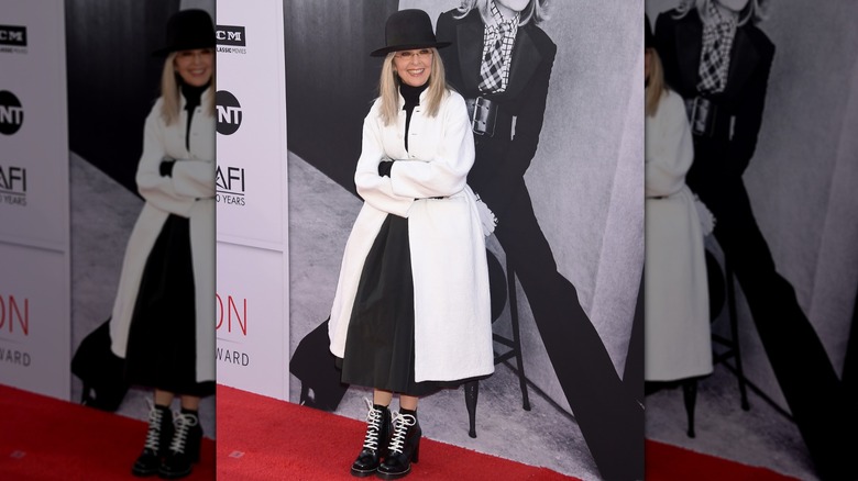 Diane Keaton wearing a white coat and black hat