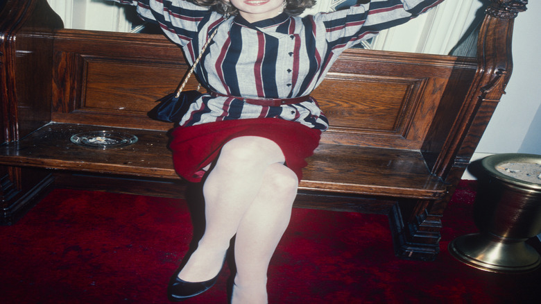 Diane Lane as a young woman with her arms up in the air