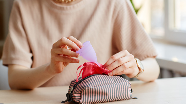woman packing a menstrual cup