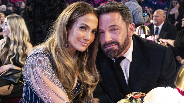 Jennifer Lopez posing with Ben Affleck at a table