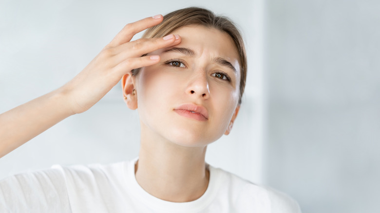  A woman assessing her face